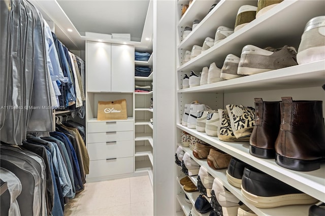 walk in closet with light tile patterned flooring