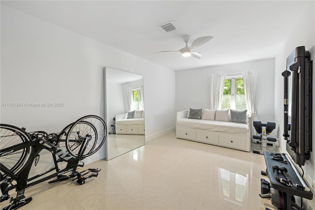 exercise room with a ceiling fan, visible vents, and baseboards