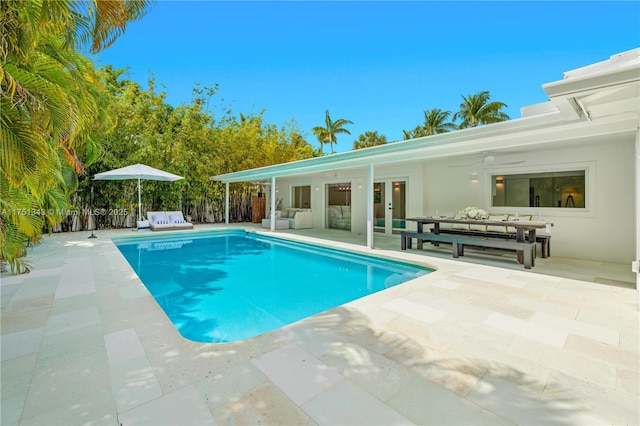 pool featuring french doors, a patio, and an outdoor hangout area