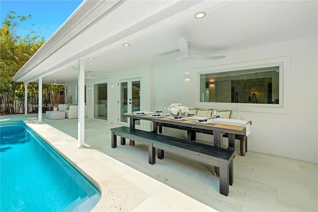 exterior space with a fenced in pool, fence, french doors, a patio area, and outdoor dining space