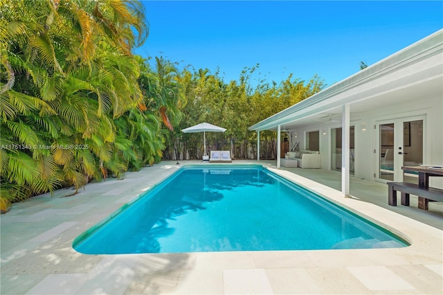 view of swimming pool featuring fence, a fenced in pool, and a patio