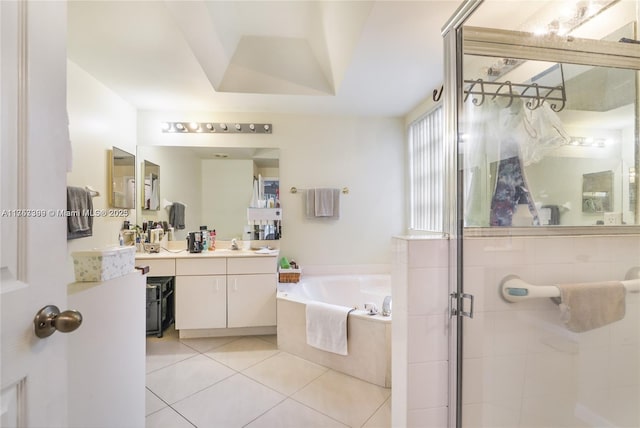 bathroom featuring a tray ceiling, a garden tub, a stall shower, vanity, and tile patterned floors