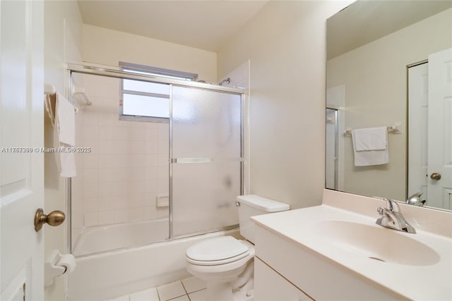 full bathroom with tile patterned flooring, vanity, toilet, and bath / shower combo with glass door