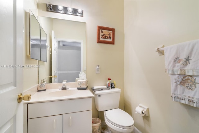 half bathroom with vanity and toilet