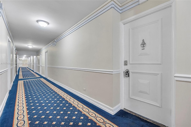 hallway with baseboards and ornamental molding