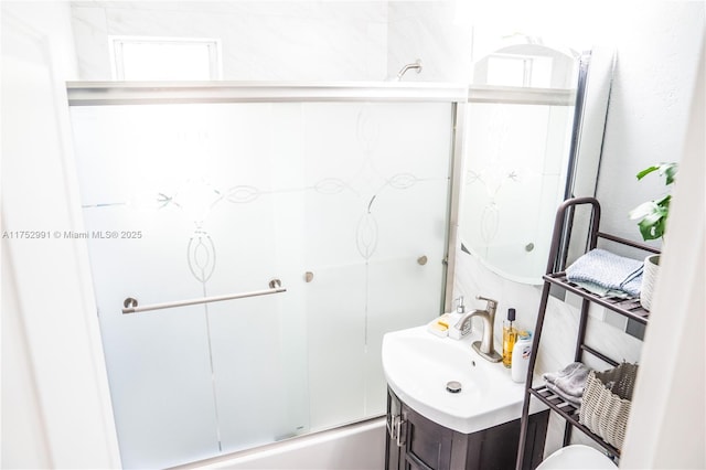 full bath featuring combined bath / shower with glass door and vanity