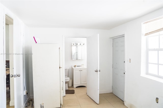 interior space featuring toilet, tile patterned floors, and vanity