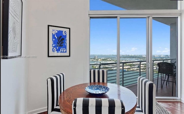 dining space featuring a city view and wood finished floors