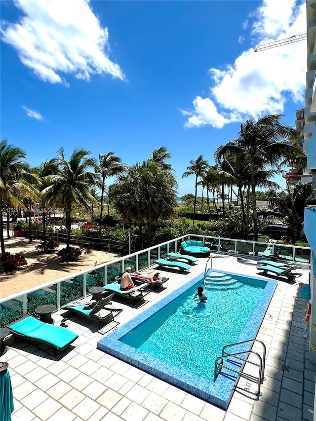 community pool with a patio area