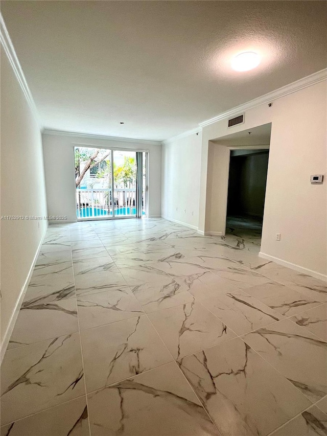 unfurnished room with ornamental molding, marble finish floor, visible vents, and a textured ceiling