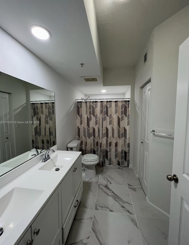 full bathroom featuring marble finish floor, a sink, and visible vents