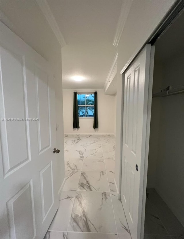 corridor with marble finish floor and baseboards