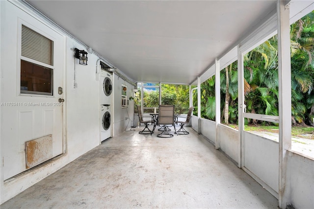 view of patio with outdoor dining space and stacked washer / dryer