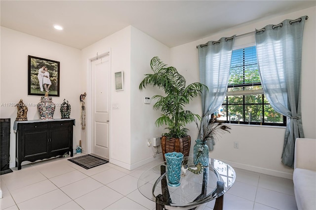 foyer featuring recessed lighting, baseboards, and light tile patterned floors