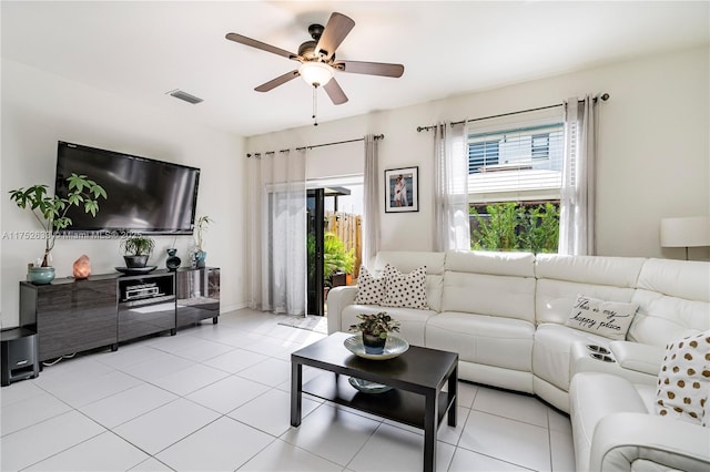 living area with a healthy amount of sunlight, ceiling fan, visible vents, and light tile patterned flooring