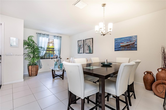 dining space featuring light tile patterned floors, baseboards, visible vents, and a chandelier