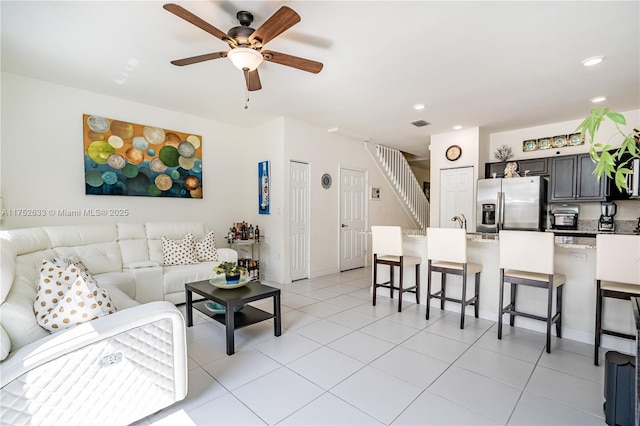 living area with stairs, light tile patterned floors, a ceiling fan, and recessed lighting