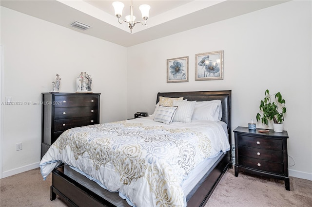 carpeted bedroom with baseboards, visible vents, a chandelier, and a raised ceiling