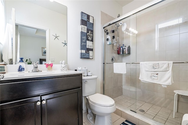 bathroom featuring a stall shower, vanity, and toilet