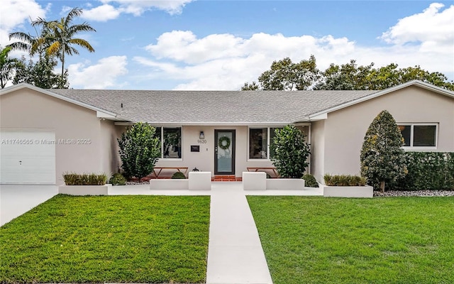 ranch-style house featuring a garage, roof with shingles, a front lawn, and stucco siding