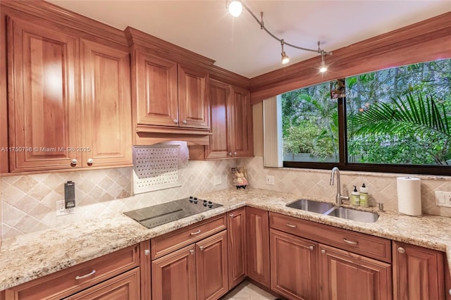 1698 S Ocean Ln Unit 171, Fort Lauderdale, FL 33316 - kitchen featuring a sink, light stone counters, decorative backsplash, and black electric stovetop