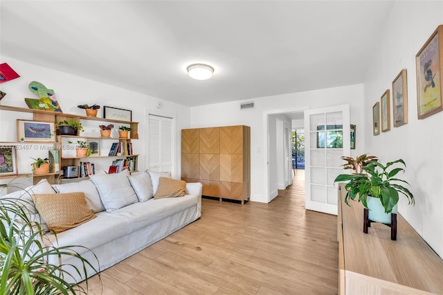 living room with light wood-type flooring and visible vents