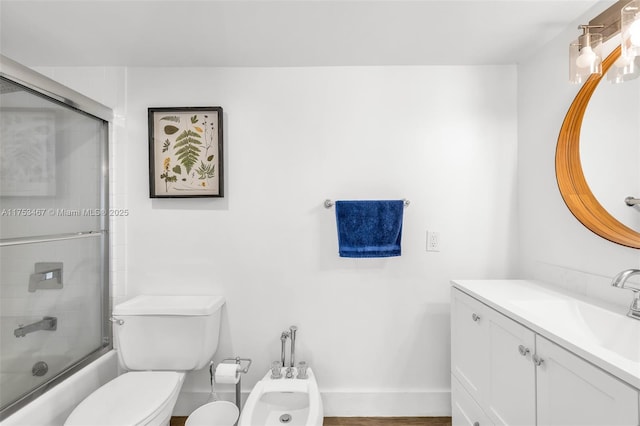 full bathroom with toilet, combined bath / shower with glass door, a bidet, vanity, and baseboards