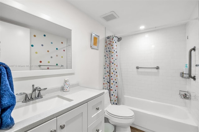 bathroom featuring visible vents, vanity, toilet, and shower / bath combo with shower curtain