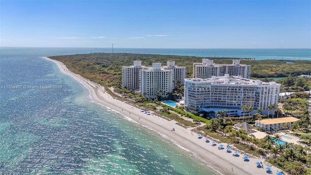 birds eye view of property with a view of city, a beach view, and a water view