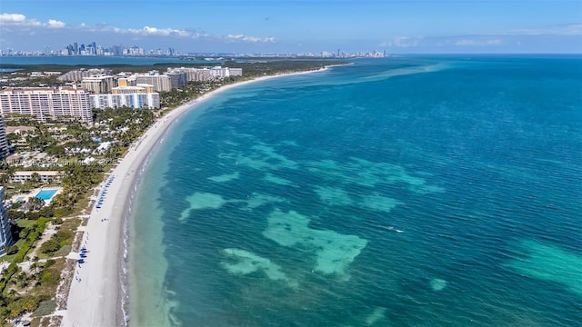 aerial view featuring a view of city, a beach view, and a water view