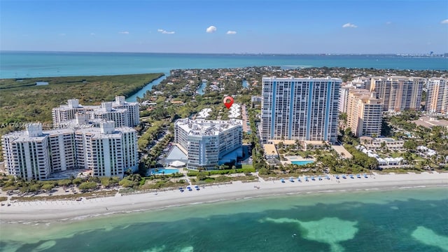 drone / aerial view with a view of the beach, a water view, and a city view