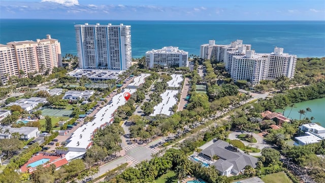 birds eye view of property with a water view and a city view