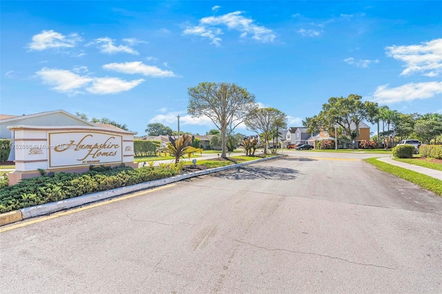 view of road with sidewalks, a residential view, and curbs