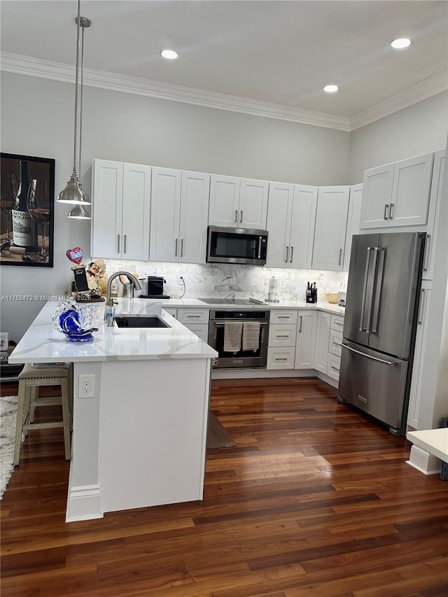 kitchen with dark wood-type flooring, a sink, appliances with stainless steel finishes, light stone countertops, and crown molding