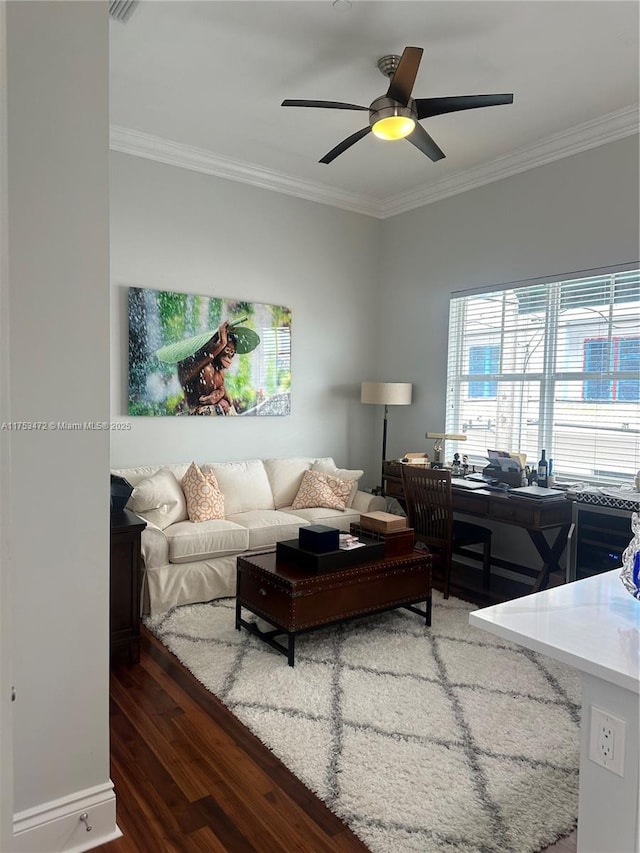 living room with crown molding, ceiling fan, and wood finished floors