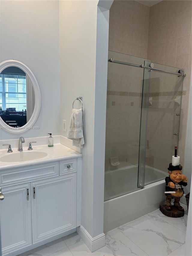 bathroom with enclosed tub / shower combo, marble finish floor, vanity, and baseboards