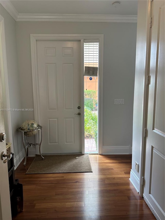 foyer with ornamental molding, dark wood-type flooring, and baseboards