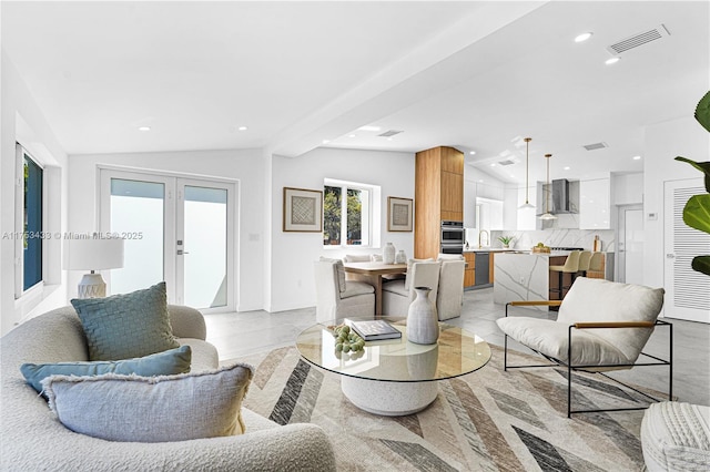 living area with recessed lighting, french doors, visible vents, and vaulted ceiling