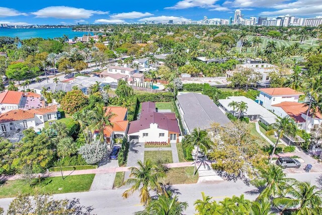 birds eye view of property with a view of city and a water view