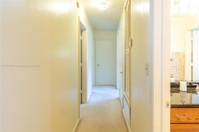 hallway with light colored carpet