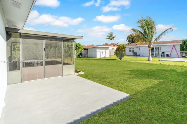 view of yard with visible vents, a patio area, fence, and a sunroom