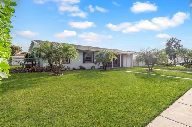 single story home featuring stucco siding, an attached garage, a front yard, fence, and driveway