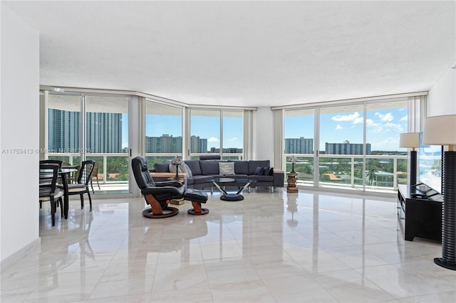 living room featuring a textured ceiling, baseboards, and floor to ceiling windows