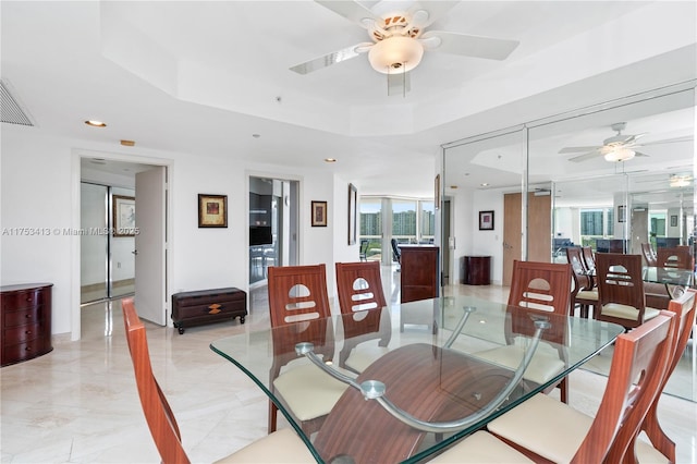 dining space with a ceiling fan, a tray ceiling, visible vents, and recessed lighting