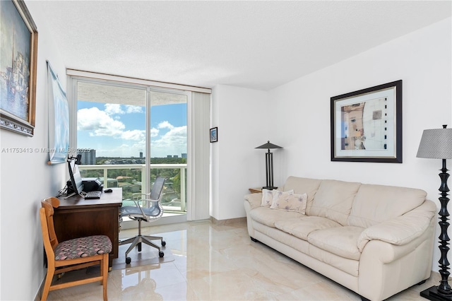 office area with expansive windows and a textured ceiling