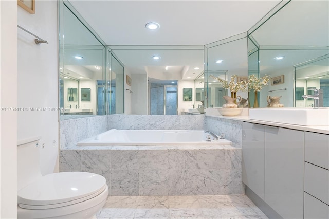 bathroom featuring toilet, recessed lighting, vanity, a bath, and a stall shower