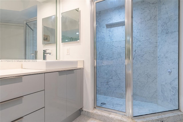 full bathroom featuring a shower stall and vanity