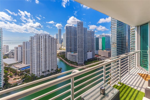 balcony with a water view and a city view