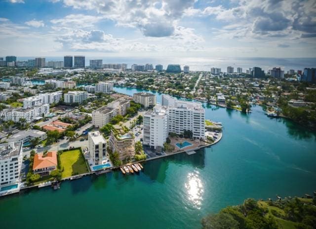 drone / aerial view featuring a water view and a view of city