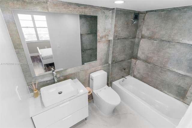 full bath featuring shower / bath combination, toilet, tile walls, and vanity